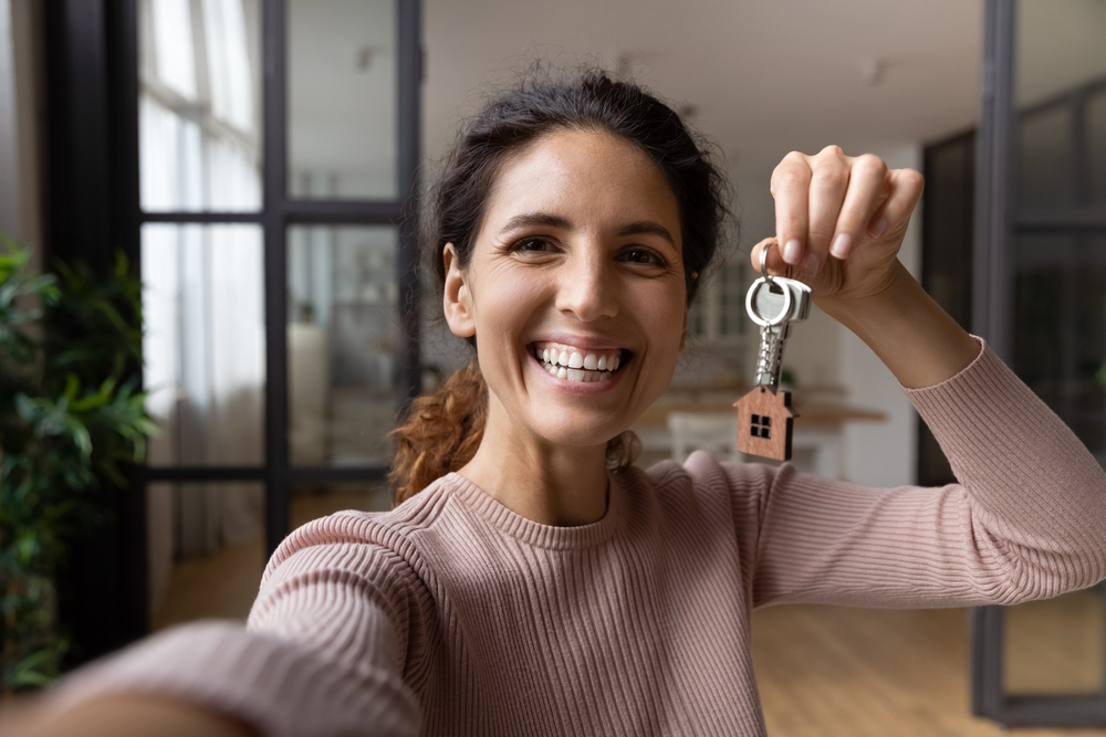 woman holding keys to new apartment