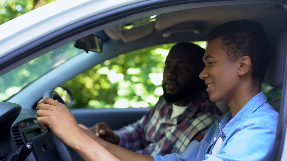 teen driver in car with dad