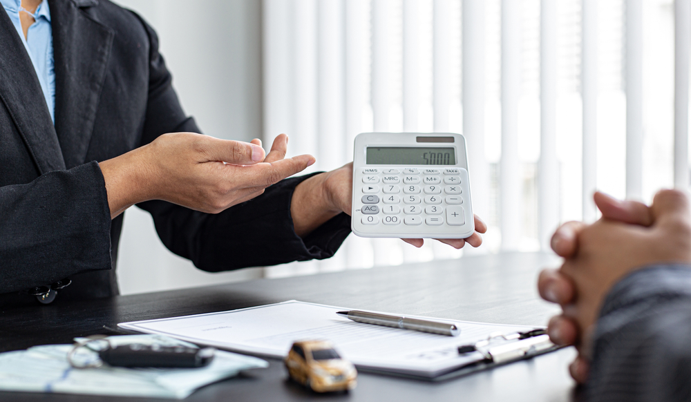 insurance agent showing calculator to client