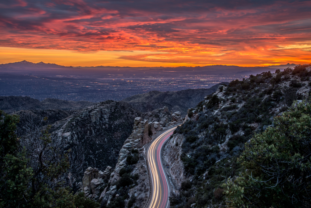 Cars driving up and down a mountain pass. Taken at sunset from Geology Vista, Mount Lemmon, Tucson, Arizona.